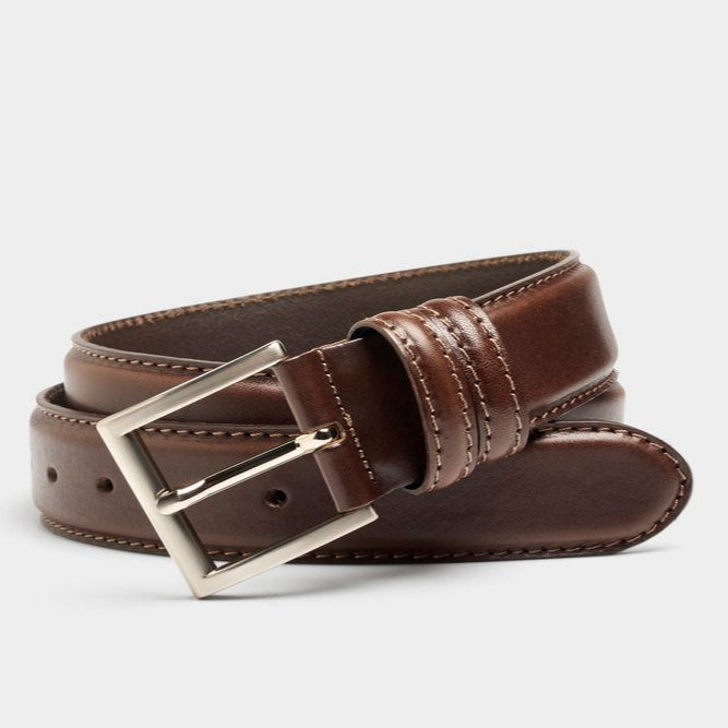 Brown leather belt with a silver buckle on a light gray background
