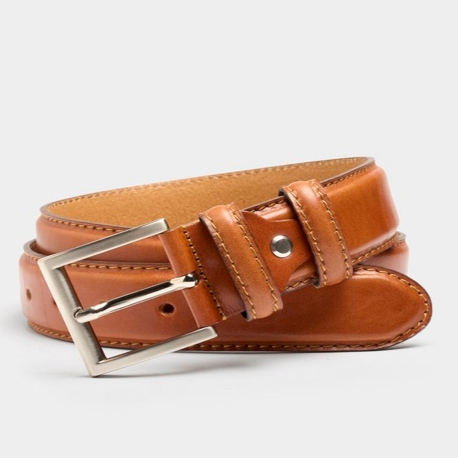 Brown leather belt with a silver buckle on a light gray background