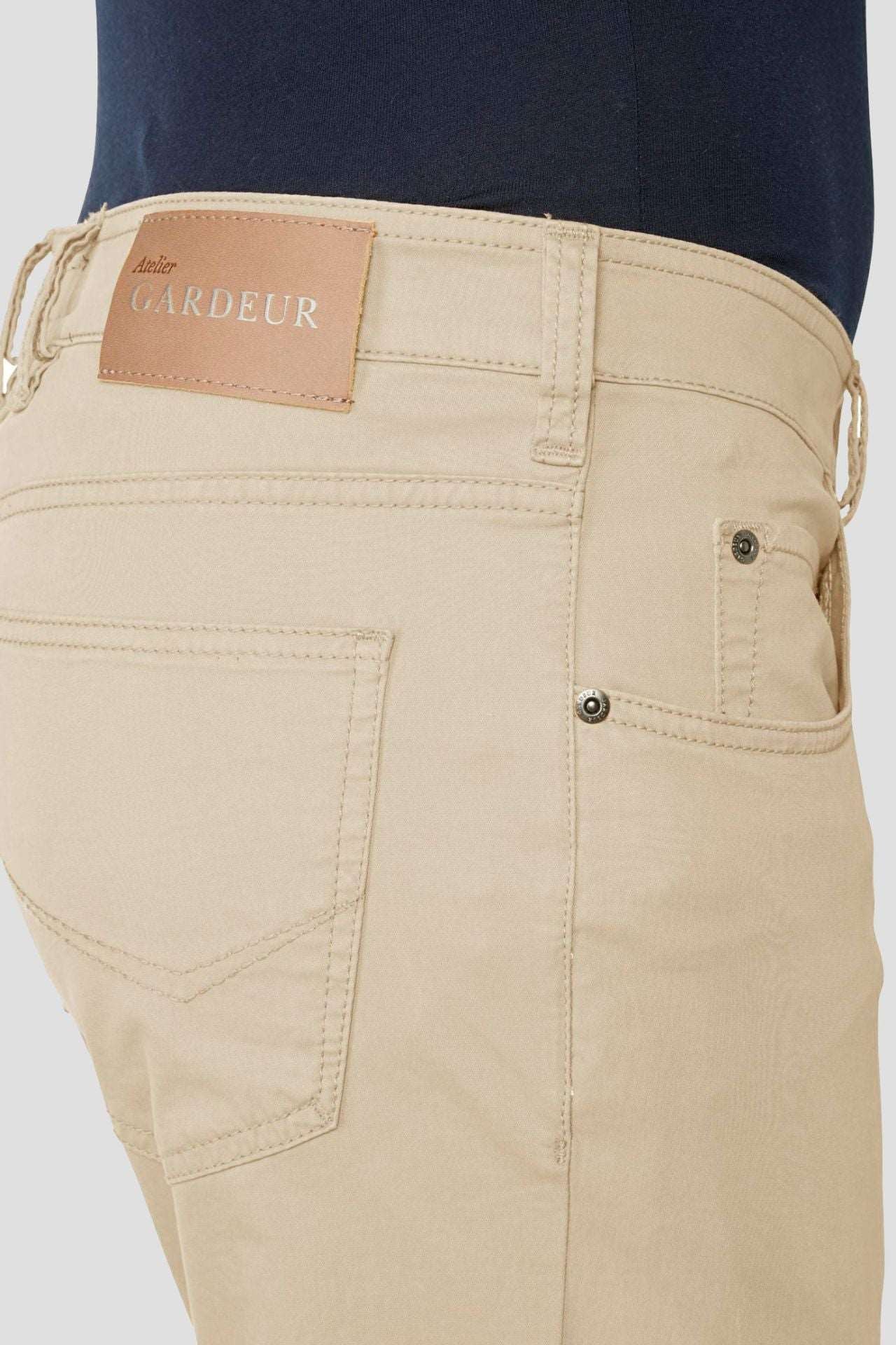 a model wearing Garduer Cotton Flex Trousers Beige cropped to show the right front and rear pocket with the Gardeur badge 