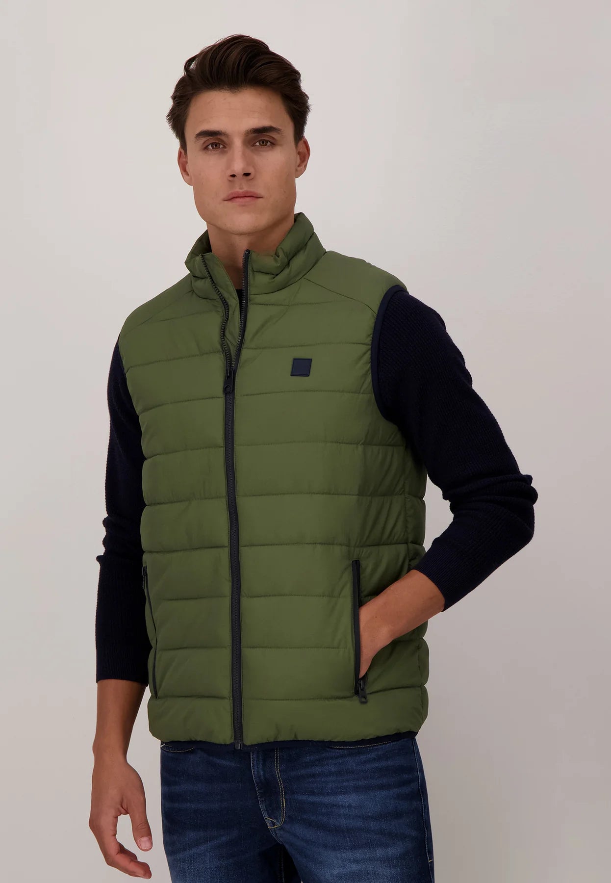 A Model Wearing Fynch-Hatton Quilted Top Padded Gilet Olive Green Front side view with Hand in his Pocket